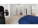 Bright bedroom with neutral carpet, white walls, and a glimpse into the en suite bathroom at 2175 S Joliet St, Aurora, CO 80014