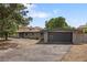 View of the home's exterior and garage, showcasing the paved driveway and a glimpse of the backyard at 2175 S Joliet St, Aurora, CO 80014