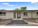 Mid-century modern home featuring a stylish front door and beautifully xeriscaped front yard at 2175 S Joliet St, Aurora, CO 80014