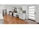 Bright kitchen featuring white cabinets, stainless steel appliances, and hardwood floors at 2175 S Joliet St, Aurora, CO 80014