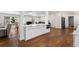 Bright white kitchen featuring stainless steel appliances, wood floors, and an open concept design at 2175 S Joliet St, Aurora, CO 80014