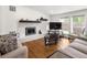 Bright living room with brick fireplace, hardwood floors and large windows at 2175 S Joliet St, Aurora, CO 80014
