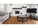 Cozy living room featuring a fireplace, hardwood floors, and neutral decor at 2175 S Joliet St, Aurora, CO 80014