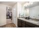 Bright bathroom featuring dual sinks, granite countertops, and a spacious walk-in closet at 2243 Villageview Ln, Castle Rock, CO 80104