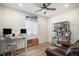Well-lit home office with desk, shelving, leather chair, and modern decor at 2243 Villageview Ln, Castle Rock, CO 80104