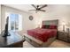 Inviting bedroom with a ceiling fan, window, and a wooden bedframe with side tables at 2243 Villageview Ln, Castle Rock, CO 80104