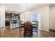 Cozy dining area with a wooden table, open to the kitchen, and filled with lots of natural light at 2243 Villageview Ln, Castle Rock, CO 80104