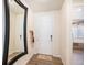 Bright entryway featuring hardwood floors, a large mirror, and a convenient coat rack at 2243 Villageview Ln, Castle Rock, CO 80104