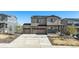 Two-story home with a three-car garage, stone accents, solar panels, and a welcoming front porch at 2243 Villageview Ln, Castle Rock, CO 80104