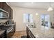 Open kitchen showcasing granite countertops, modern appliances, and a view of the outdoor scenery at 2243 Villageview Ln, Castle Rock, CO 80104