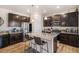 Spacious kitchen featuring an island, granite counters, stainless appliances, and wood grain flooring at 2243 Villageview Ln, Castle Rock, CO 80104