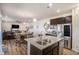 Bright and open kitchen area with a kitchen island, granite countertops, and modern appliances at 2243 Villageview Ln, Castle Rock, CO 80104