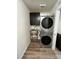 Cozy laundry room with stainless steel utility sink and modern, stackable washer and dryer at 2243 Villageview Ln, Castle Rock, CO 80104