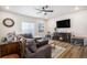 Comfortable living room with a fireplace, large sectional sofa, and stylish decor at 2243 Villageview Ln, Castle Rock, CO 80104