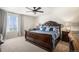 Inviting main bedroom features a large bed, side tables, lamps, and a scenic window view at 2243 Villageview Ln, Castle Rock, CO 80104