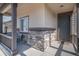 Inviting front porch with stone accents, seating, and a view of the home's entrance at 2243 Villageview Ln, Castle Rock, CO 80104