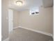 Unfinished basement with a new door and a window for natural light at 1901 S Lincoln St, Denver, CO 80210