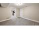 Finished basement with neutral paint, carpet, and an open doorway to another room at 1901 S Lincoln St, Denver, CO 80210