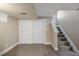 Finished basement featuring carpeted stairs, a closet, and neutral paint at 1901 S Lincoln St, Denver, CO 80210