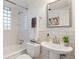 Classic bathroom features white subway tile, glass block window, and pedestal sink at 1901 S Lincoln St, Denver, CO 80210