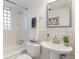 Clean bathroom showcasing a pedestal sink, subway tiles, and modern fixtures at 1901 S Lincoln St, Denver, CO 80210