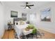 Light and airy bedroom with hardwood floors, ceiling fan, and neutral decor at 1901 S Lincoln St, Denver, CO 80210