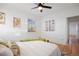 Bright bedroom with ceiling fan, hardwood floors, and view of the trees outside at 1901 S Lincoln St, Denver, CO 80210