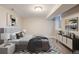 Basement bedroom with gray upholstered bed at 1901 S Lincoln St, Denver, CO 80210