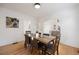 Bright dining room boasts hardwood floors and stylish table with seating for six at 1901 S Lincoln St, Denver, CO 80210