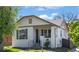 Charming white brick home with a welcoming front porch and nicely landscaped front yard at 1901 S Lincoln St, Denver, CO 80210