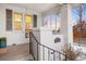 Charming front porch with swing, white brick surround and black iron railing at 1901 S Lincoln St, Denver, CO 80210