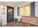 Inviting front porch with a wooden swing bench and gray shutters at 1901 S Lincoln St, Denver, CO 80210