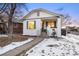 Charming bungalow with a freshly painted exterior and snowy lawn at 1901 S Lincoln St, Denver, CO 80210