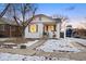 Charming bungalow with a freshly painted exterior and snowy lawn at 1901 S Lincoln St, Denver, CO 80210