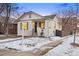 Charming bungalow with a freshly painted exterior and snowy lawn at 1901 S Lincoln St, Denver, CO 80210