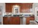 Updated kitchen boasts granite countertops, stainless steel appliances, and dark wood cabinetry at 1901 S Lincoln St, Denver, CO 80210