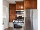 Modern kitchen features stainless steel appliances and ample cabinet space for storage at 1901 S Lincoln St, Denver, CO 80210