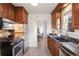 Modern kitchen featuring stainless steel appliances, granite countertops, and sleek dark-wood cabinets at 1901 S Lincoln St, Denver, CO 80210