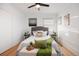 Cozy bedroom with plush bed, stylish decor, ceiling fan, and ample natural light at 1901 S Lincoln St, Denver, CO 80210