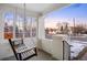 Inviting front porch with a swing, white brick pillars, and scenic neighborhood views at 1901 S Lincoln St, Denver, CO 80210