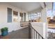 Inviting front porch with a swing, white brick pillars, and blue shutters at 1901 S Lincoln St, Denver, CO 80210