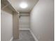 Large walk-in closet featuring ample storage space and neutral carpeting at 1901 S Lincoln St, Denver, CO 80210