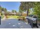 Spacious backyard featuring a concrete patio, lawn, wooden fence, and a BBQ grill; great for outdoor entertaining at 2844 Bellaire St, Denver, CO 80207