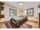 Bedroom with natural light, wood floors, stylish rug, and comfortable furnishings at 2844 Bellaire St, Denver, CO 80207