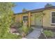 Inviting front entrance of a home, showcasing a green door, manicured landscaping, and a well-maintained walkway at 2844 Bellaire St, Denver, CO 80207