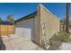 Detached garage with a white door, brick exterior, and a driveway showcasing an exterior view at 2844 Bellaire St, Denver, CO 80207