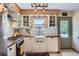 Bright kitchen featuring white cabinetry, butcher block countertops, and subway tile backsplash at 2844 Bellaire St, Denver, CO 80207