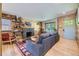 Inviting living room with wood paneling, a stone fireplace, and comfortable seating at 2844 Bellaire St, Denver, CO 80207