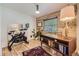 Bright office with a wood accent wall, comfortable desk, and exercise bike at 2844 Bellaire St, Denver, CO 80207