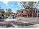 Street view of charming brick buildings, local shops, and tree-lined sidewalks at 2844 Bellaire St, Denver, CO 80207